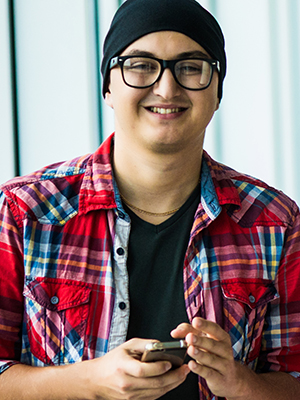 Guy in glasses and plaid shirt smiling